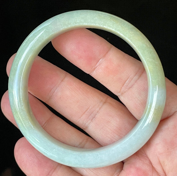 Close-up of fine crystalline texture and gentle light lavender hues on icy apple green and white jadeite bangle