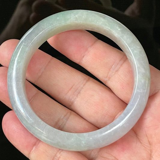 Close-up of fine crystalline texture and apple green hues on very icy lavender and white jadeite bangle
