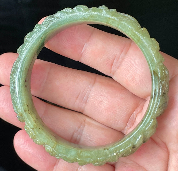 Solid icy apple green natural Type A Burmese jade bangle bracelet with carved floral design, size 58.3mm