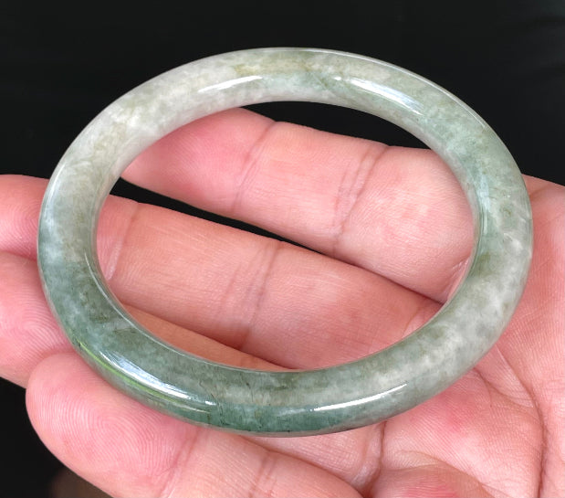 Solid icy apple green and milky white natural Type A Burmese jade bangle bracelet in size 56.8mm