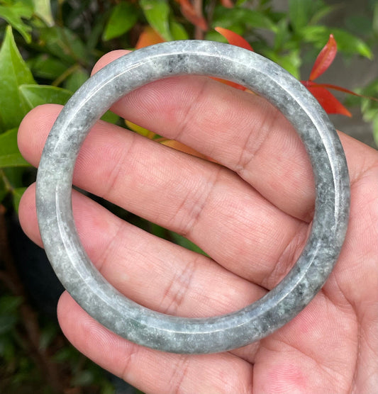 Solid icy grayish black and milky white natural Type A Burmese jade bangle bracelet in size 59.2mm