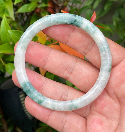 Solid icy imperial green and milky white natural Type A Burmese jade bangle bracelet in size 59.5mm