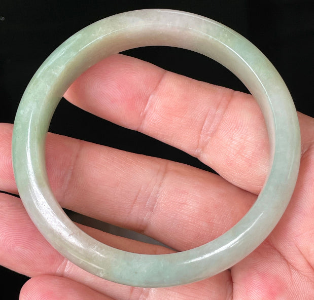Rounded classic profile of 57mm icy apple green and milky white Burmese jade bangle JB079