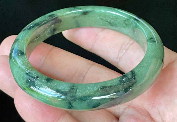 Flat inner and round outer edges of 58mm icy apple green and black floral Burmese jade bangle JB905