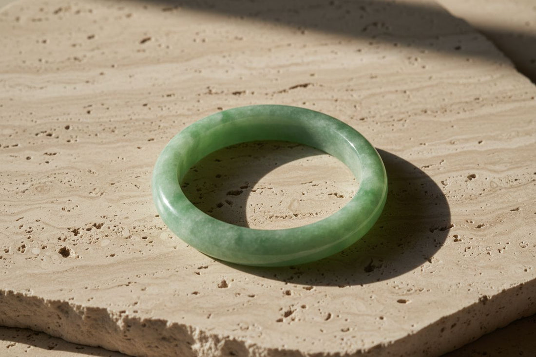 Authentic Burmese Type A jade bangle displayed in luxury editorial jewelry photography.