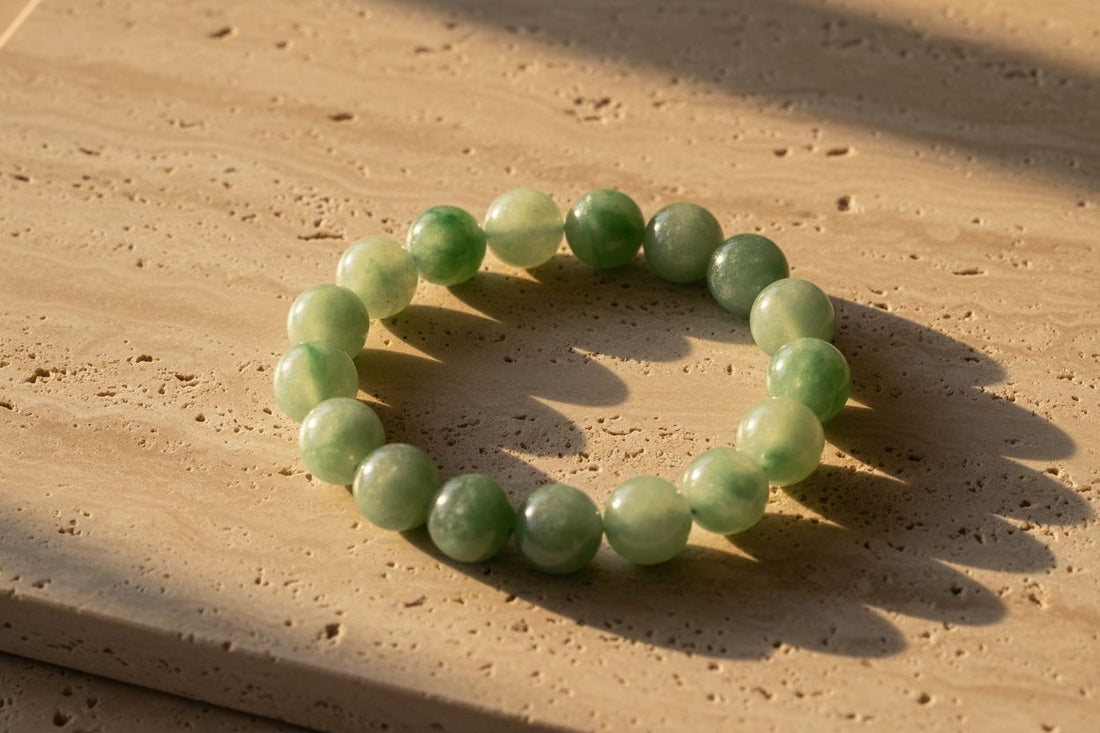 Authentic untreated Burmese Type A jade bead bracelet displayed in luxury editorial style.