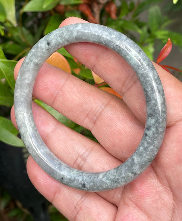 Video showcasing the vitreous luster and beautiful icy grayish black and milky white hues of the 59.2mm Burmese jade bangle JB945