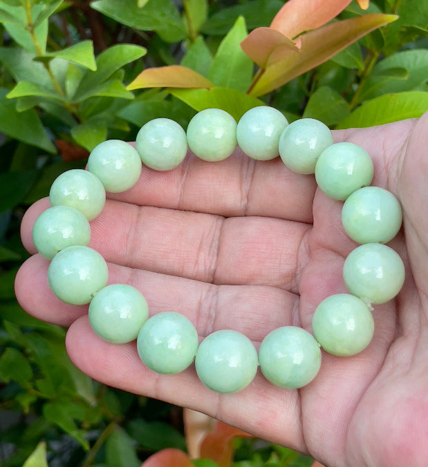 Vitreous luster and fine texture of the authentic Myanmar jade bead bracelet JBB171 showcasing a harmonious green and white color palette