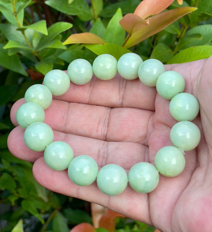 Vitreous luster and fine texture of the authentic Myanmar jade bead bracelet JBB171 showcasing a harmonious green and white color palette