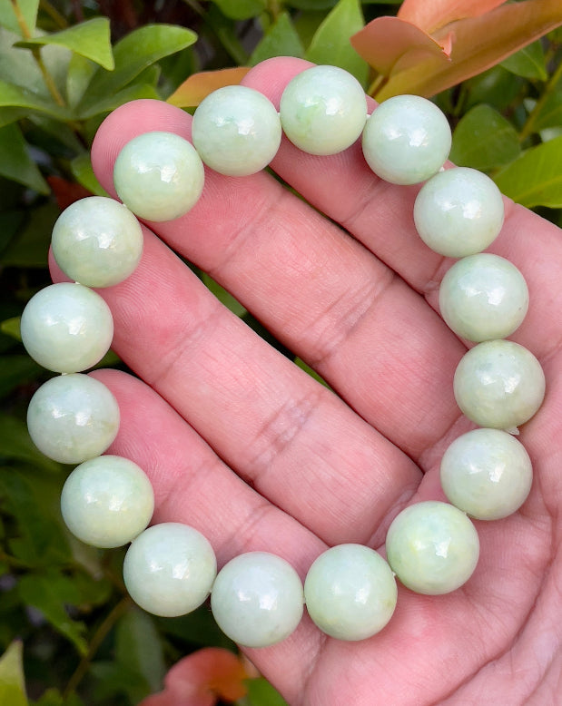 Vitreous luster and fine texture of the authentic Myanmar jade bead bracelet JBB171 showcasing a harmonious green and white color palette
