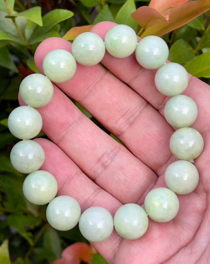 Vitreous luster and fine texture of the authentic Myanmar jade bead bracelet JBB171 showcasing a harmonious green and white color palette