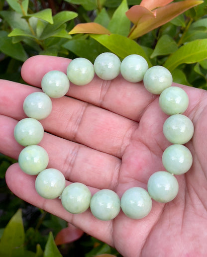 Vitreous luster and fine texture of the authentic Myanmar jade bead bracelet JBB171 showcasing a harmonious green and white color palette