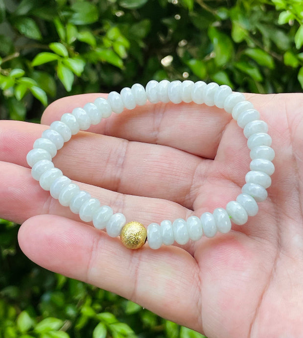Vitreous luster and fine texture of the authentic Myanmar jade bead bracelet JBB166 with a golden accent