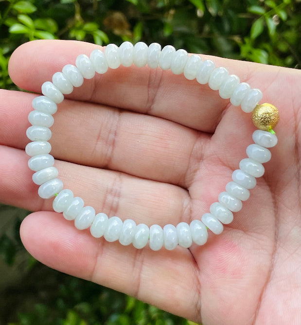 Vitreous luster and fine texture of the authentic Myanmar jade bead bracelet JBB166 with a golden accent