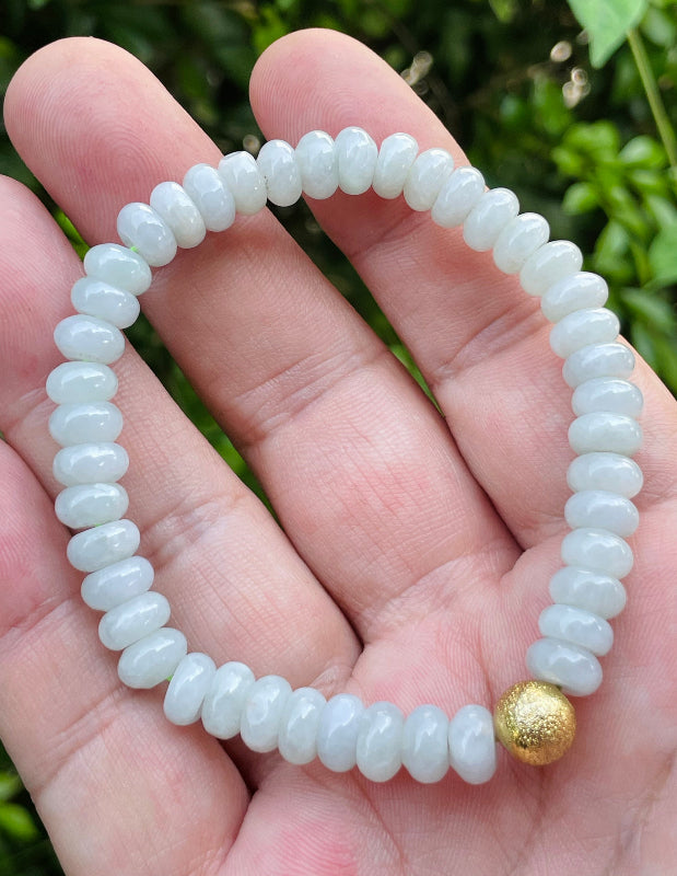 Vitreous luster and fine texture of the authentic Myanmar jade bead bracelet JBB166 with a golden accent