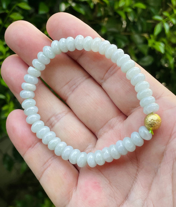 Vitreous luster and fine texture of the authentic Myanmar jade bead bracelet JBB166 with a golden accent