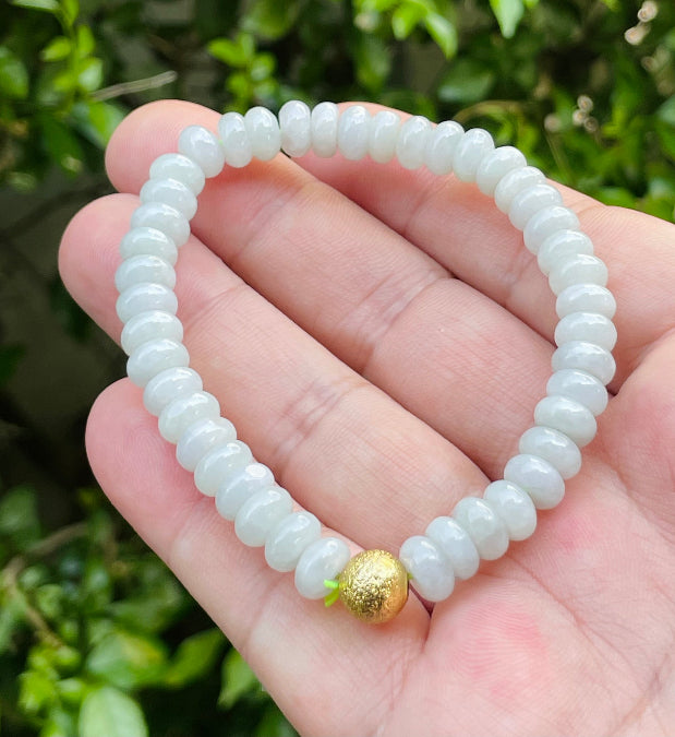 Vitreous luster and fine texture of the authentic Myanmar jade bead bracelet JBB166 with a golden accent