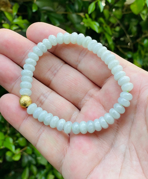 Vitreous luster and fine texture of the authentic Myanmar jade bead bracelet JBB169 with a gold-tone accent