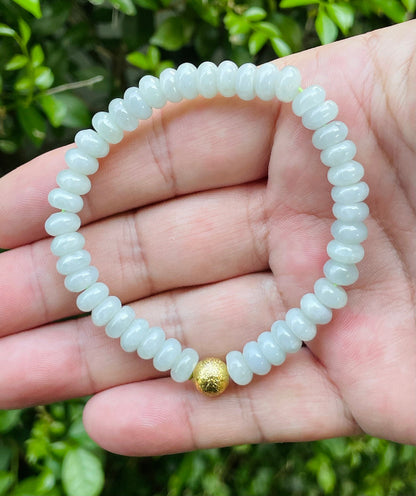 Vitreous luster and fine texture of the authentic Myanmar jade bead bracelet JBB169 with a gold-tone accent
