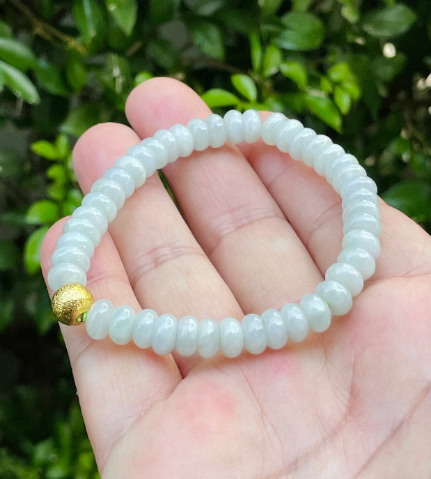 Vitreous luster and fine texture of the authentic Myanmar jade bead bracelet JBB169 with a gold-tone accent
