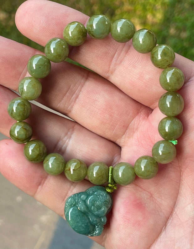 Vitreous luster and fine texture of the authentic Myanmar jade bead bracelet JBB179 with a joy and abundance Laughing Buddha charm