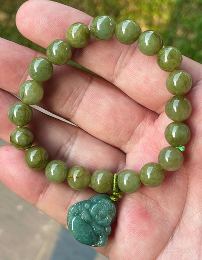 Vitreous luster and fine texture of the authentic Myanmar jade bead bracelet JBB179 with a joy and abundance Laughing Buddha charm