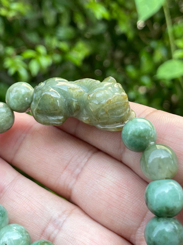 Vitreous luster and fine texture of the authentic Myanmar jade bead bracelet JBB164 with a wealth and protection Pixiu charm