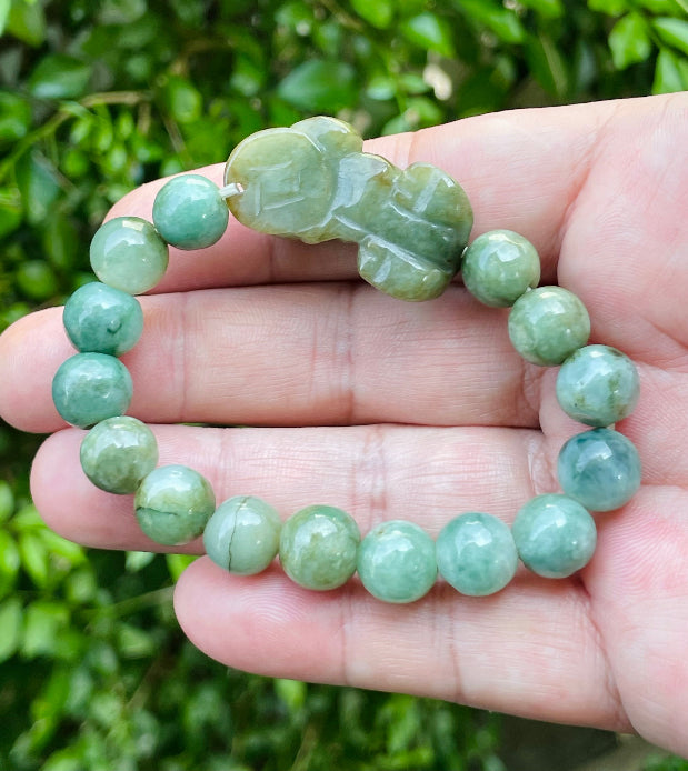 Vitreous luster and fine texture of the authentic Myanmar jade bead bracelet JBB164 with a wealth and protection Pixiu charm