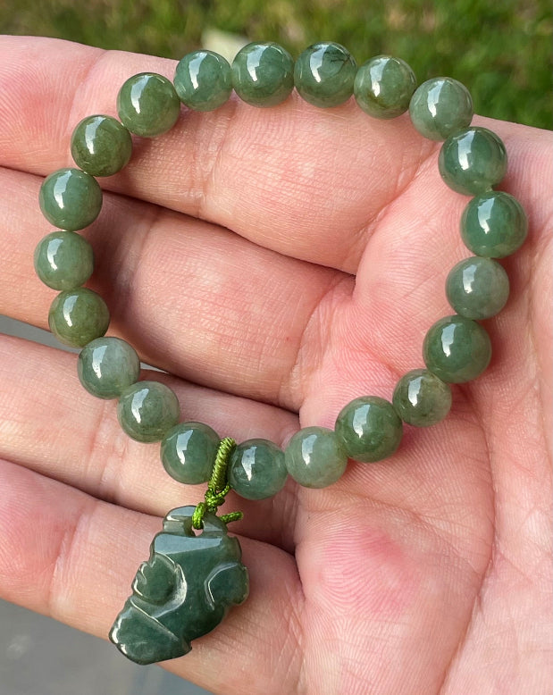 Vitreous luster and fine texture of the authentic Myanmar jade bead bracelet JBB181 with a wealth and protection Pixiu charm