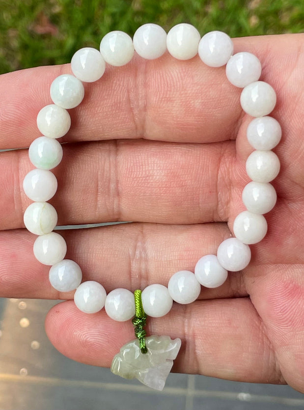 Vitreous luster and fine texture of the authentic Myanmar jade bead bracelet JBB177 with a protective tiger charm