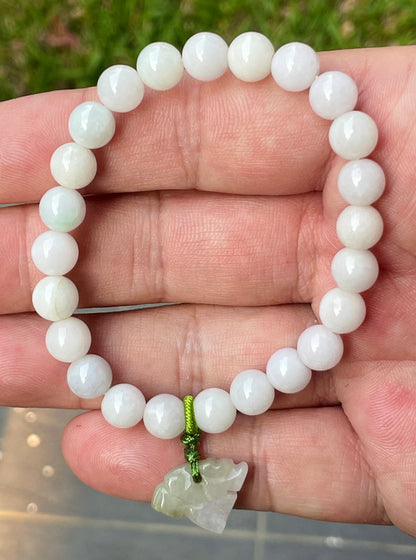Vitreous luster and fine texture of the authentic Myanmar jade bead bracelet JBB177 with a protective tiger charm