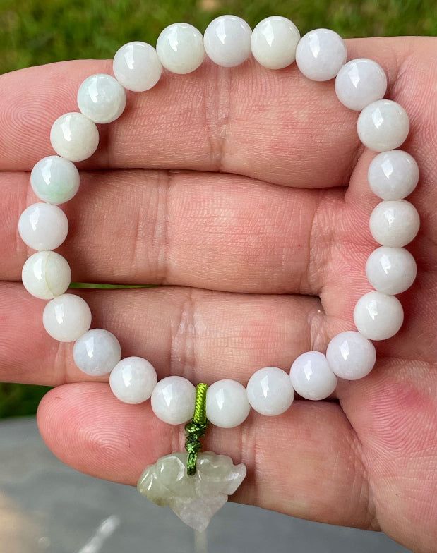 Vitreous luster and fine texture of the authentic Myanmar jade bead bracelet JBB177 with a protective tiger charm