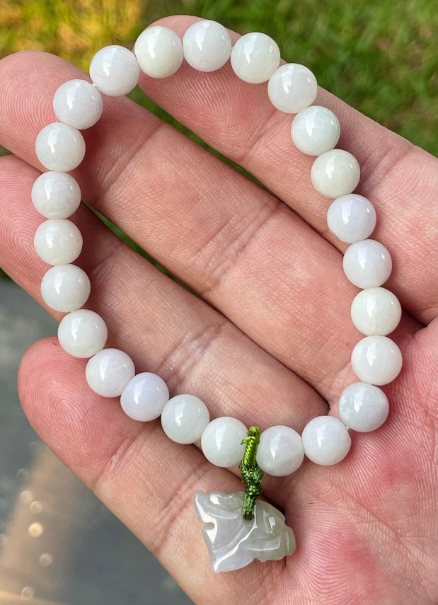 Vitreous luster and fine texture of the authentic Myanmar jade bead bracelet JBB177 with a protective tiger charm