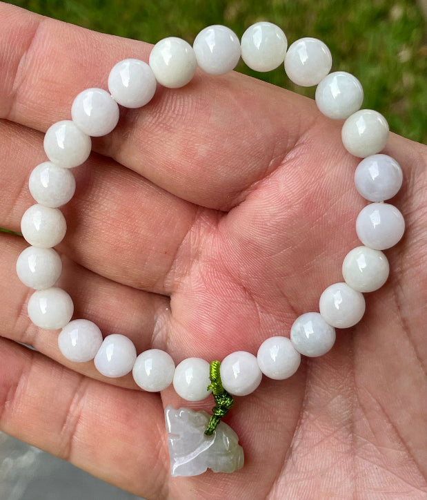 Vitreous luster and fine texture of the authentic Myanmar jade bead bracelet JBB177 with a protective tiger charm