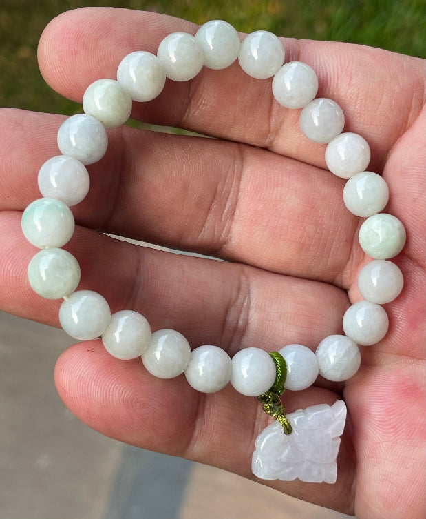 Vitreous luster and fine texture of the authentic Myanmar jade bead bracelet JBB180 with a protective tiger charm