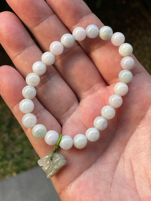 Vitreous luster and fine texture of the authentic Myanmar jade bead bracelet JBB184 with a wealth and protection tiger charm