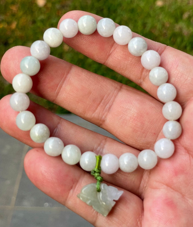 Vitreous luster and fine texture of the authentic Myanmar jade bead bracelet JBB184 with a wealth and protection tiger charm