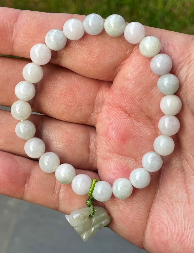 Vitreous luster and fine texture of the authentic Myanmar jade bead bracelet JBB184 with a wealth and protection tiger charm