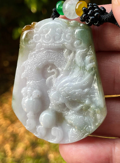 Vitreous luster and fine texture of the authentic Myanmar jade pendant JP081 showcasing a carved dragon Feng Shui design for strength and protection