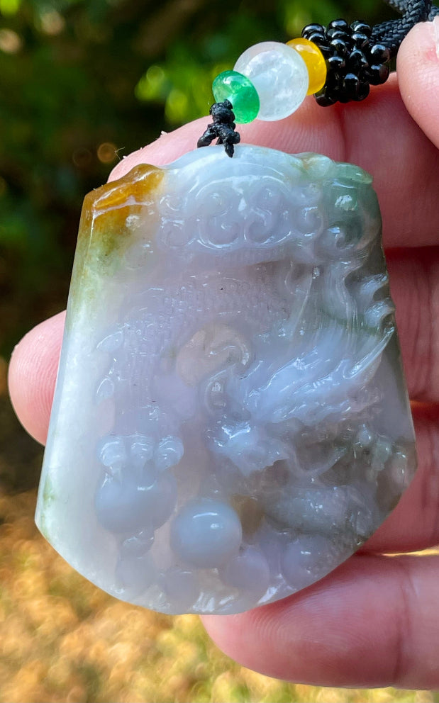 Vitreous luster and fine texture of the authentic Myanmar jade pendant JP081 showcasing a carved dragon Feng Shui design for strength and protection