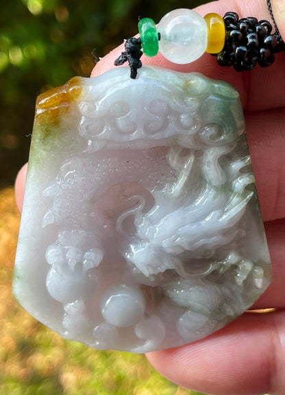 Vitreous luster and fine texture of the authentic Myanmar jade pendant JP081 showcasing a carved dragon Feng Shui design for strength and protection