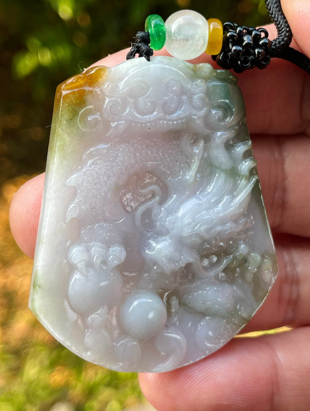 Vitreous luster and fine texture of the authentic Myanmar jade pendant JP081 showcasing a carved dragon Feng Shui design for strength and protection
