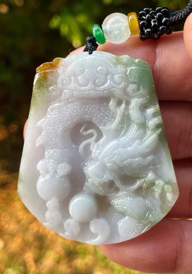 Vitreous luster and fine texture of the authentic Myanmar jade pendant JP081 showcasing a carved dragon Feng Shui design for strength and protection