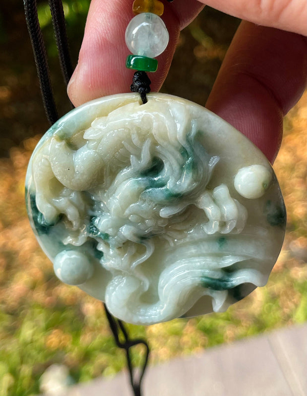 Vitreous luster and fine texture of the authentic Myanmar jade pendant JP082 showcasing a carved dragon Feng Shui design for strength and protection