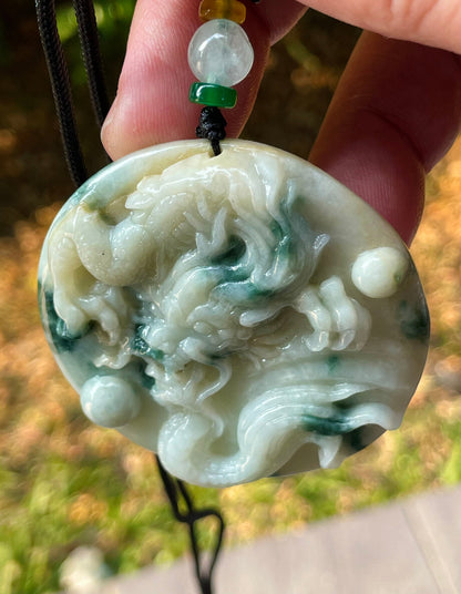 Vitreous luster and fine texture of the authentic Myanmar jade pendant JP082 showcasing a carved dragon Feng Shui design for strength and protection
