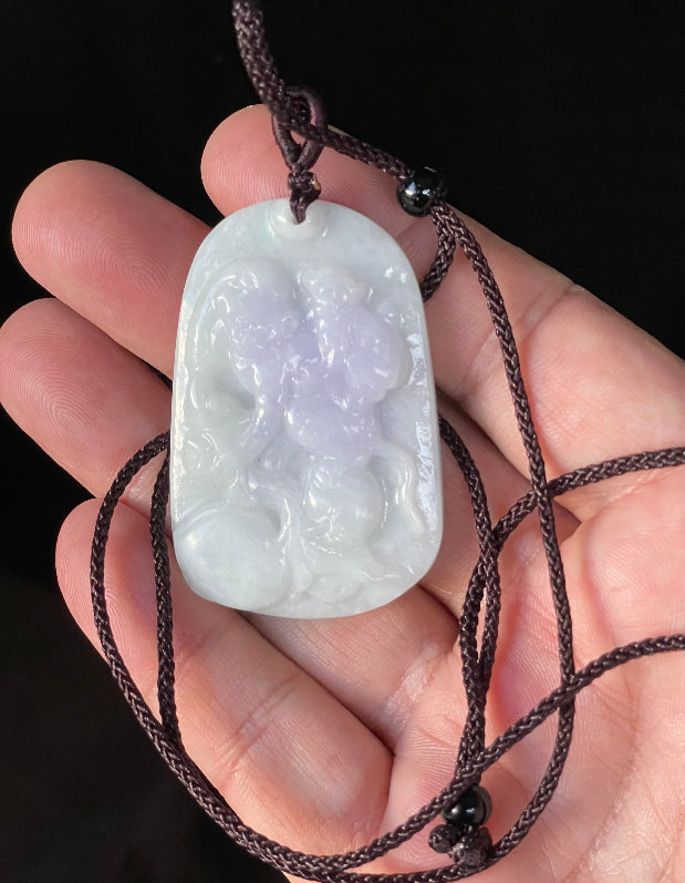 Vitreous luster and fine texture of the authentic Myanmar jade pendant JP021 showcasing a carved double monkey Feng Shui design for joy and companionship