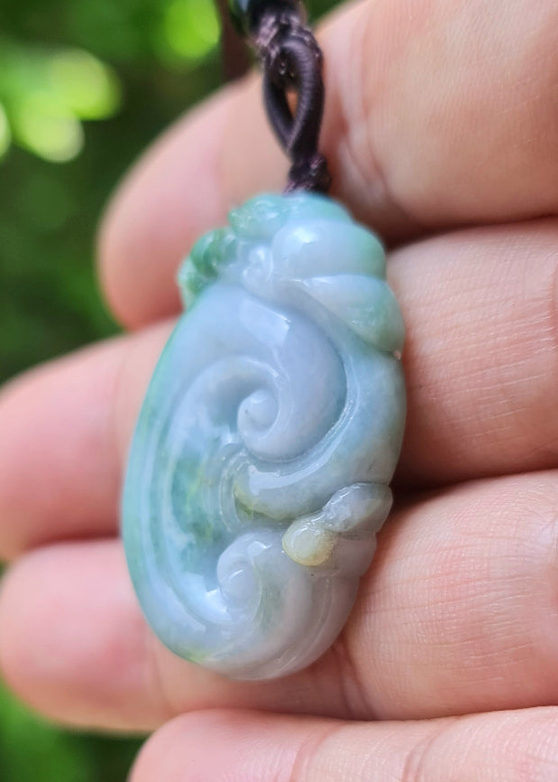 Polished texture of the authentic Myanmar jade pendant JP022 showcasing a carved ruyi scroll Feng Shui design for good fortune and wishes