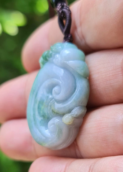Polished texture of the authentic Myanmar jade pendant JP022 showcasing a carved ruyi scroll Feng Shui design for good fortune and wishes