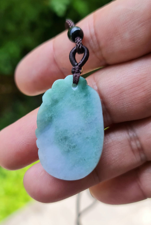 Polished texture of the authentic Myanmar jade pendant JP022 showcasing a carved ruyi scroll Feng Shui design for good fortune and wishes