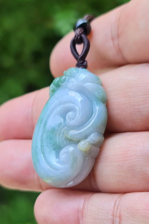 Polished texture of the authentic Myanmar jade pendant JP022 showcasing a carved ruyi scroll Feng Shui design for good fortune and wishes